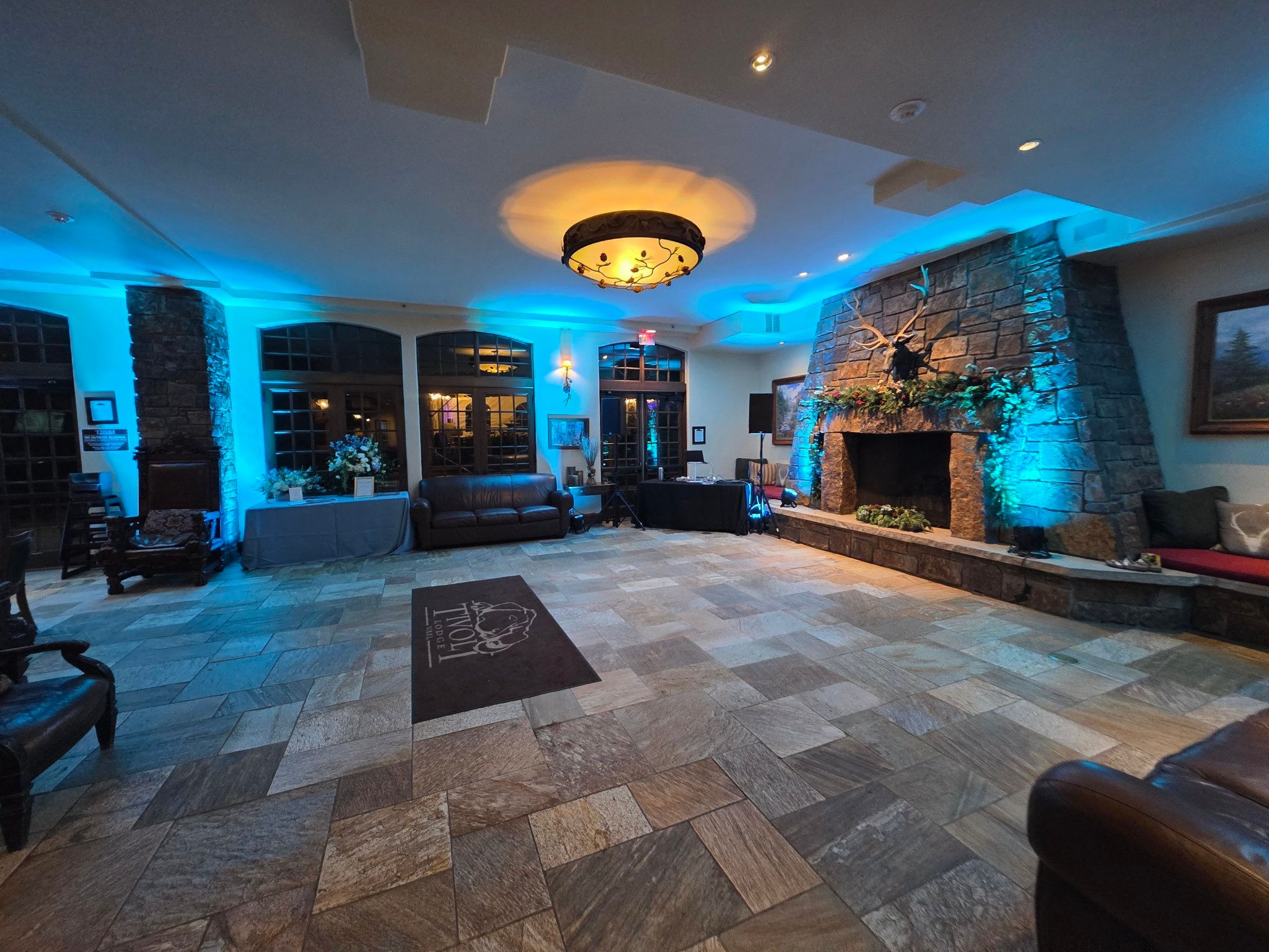DJ setup with blue uplighting at a lodge ballroom event