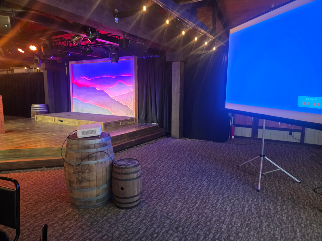 Stage with wooden barrels and a large LED video wall