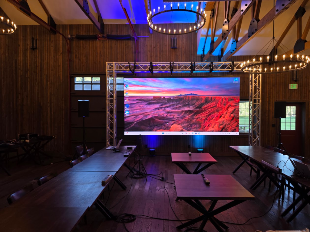 Barn venue LED wall on truss showing canyon sunset image