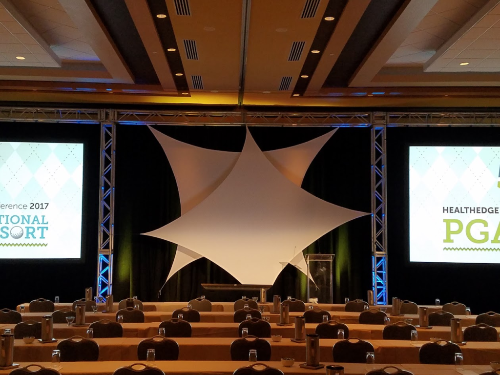 HealthEdge 2017 conference stage with white fabric sail and dual projection screens
