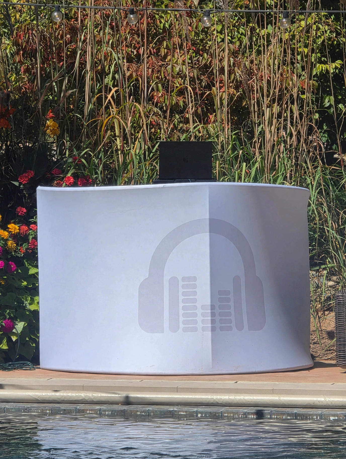 Outdoor DJ facade setup by a pool