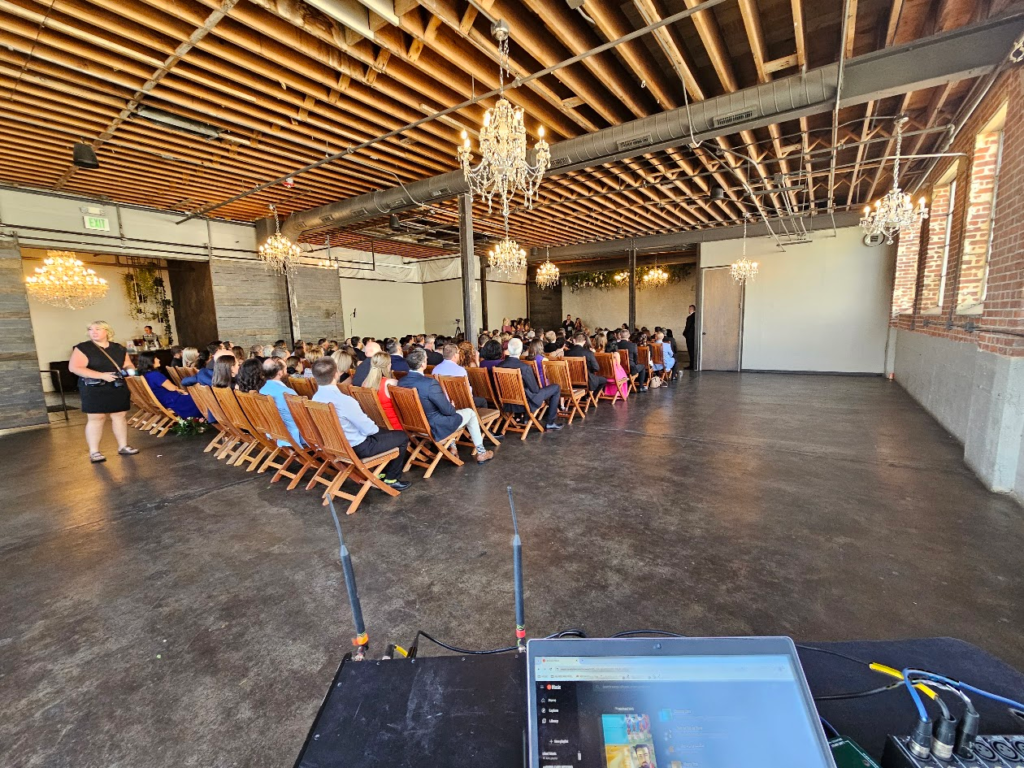 Wedding ceremony in industrial venue with chandeliers